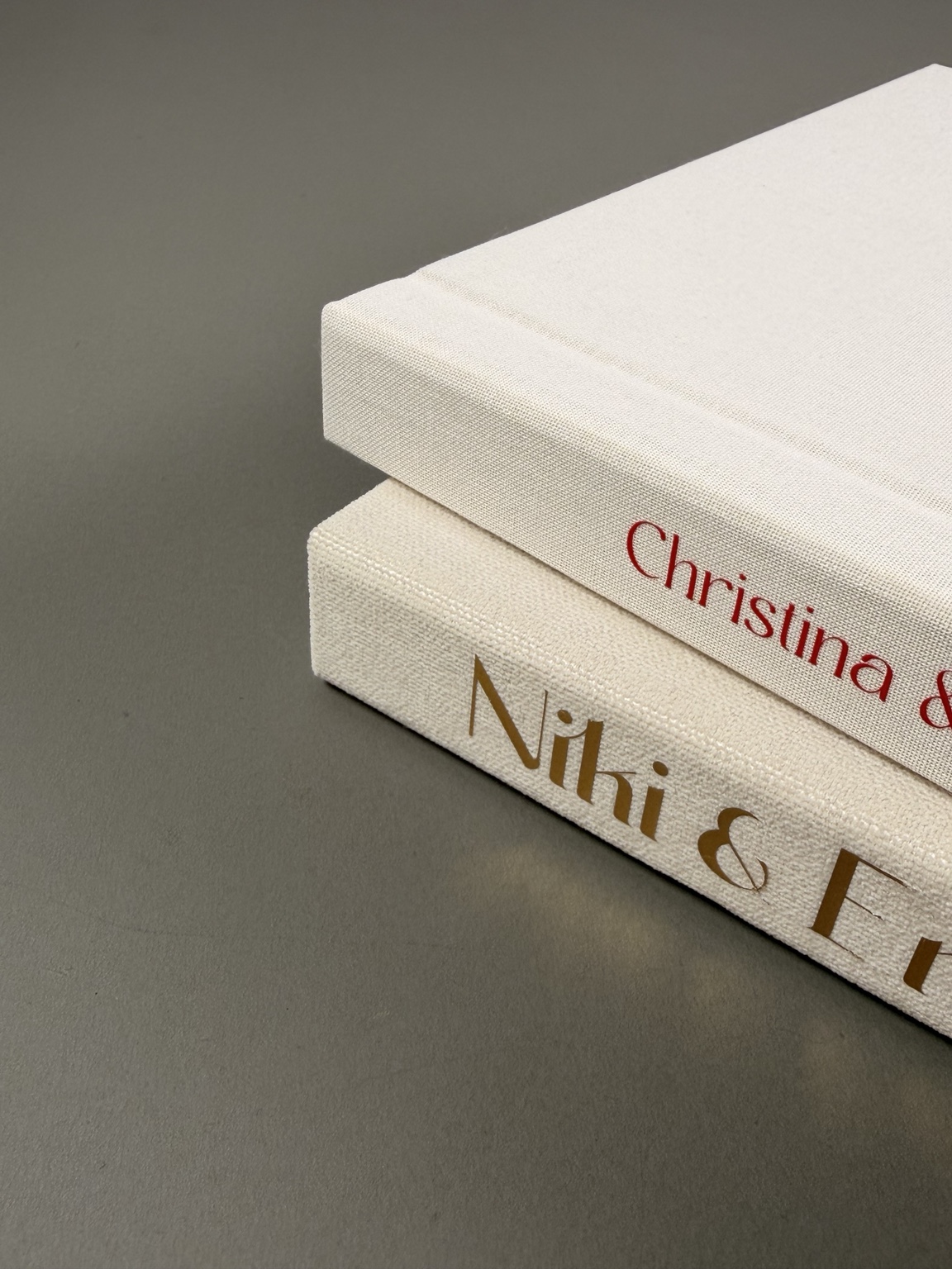 Close-up of the personalised spines and fabric texture of two handmade albums